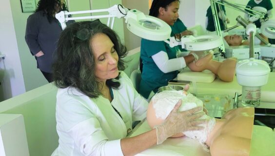 Skin Care student practicing facial techniques with her mannequin head