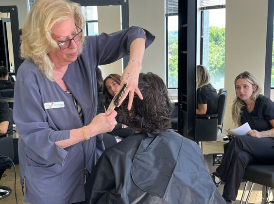 Cosmetology & Hairstyling Instructor demonstrating to class