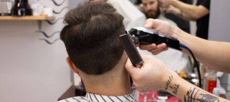 Barber shaving his male client's hair